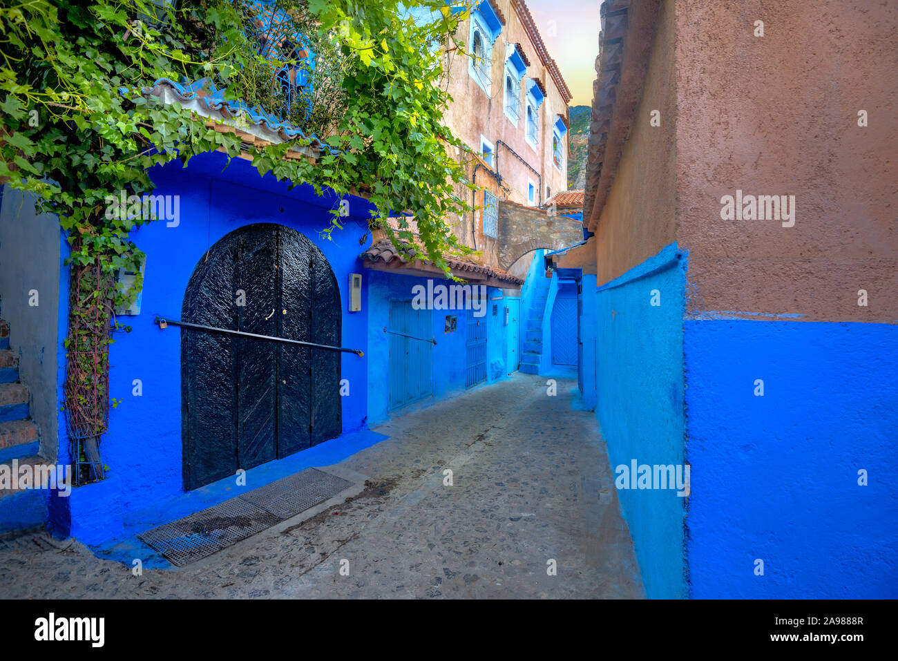 Narrow street with blue painted walls in old medina of Chefchaouen. Morocco, North Africa Stock Photo