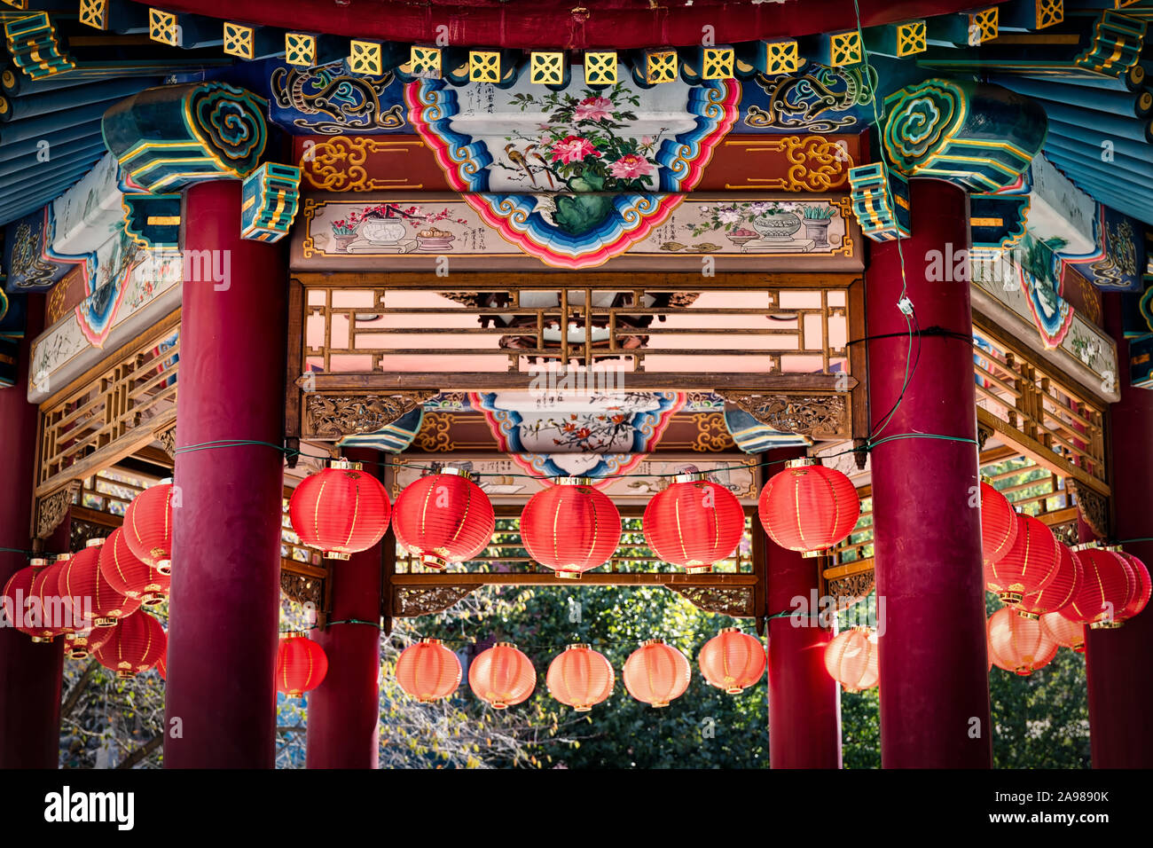 The sun shines on lamps from behind a gazebo at Chinatown in Yokohama, Japan. Stock Photo