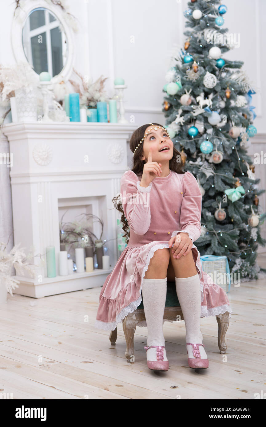 Hopeful Child New Year Eve Dreams Come True Hope Concept Dreamy Baby Christmas Wish Making Wish Waiting For Santa Claus Adorable Girl Making Wish Near Christmas Tree Decorated Interior Stock Photo