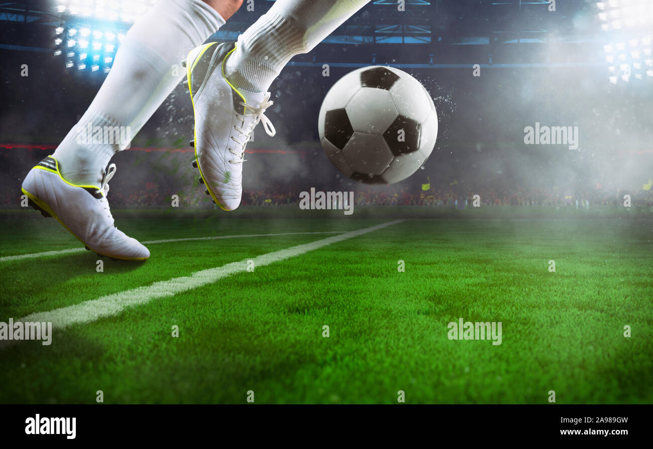 Football Scene At Night Match With Close Up Of A Soccer Player Running To Kick The Ball At The Stadium Stock Photo Alamy