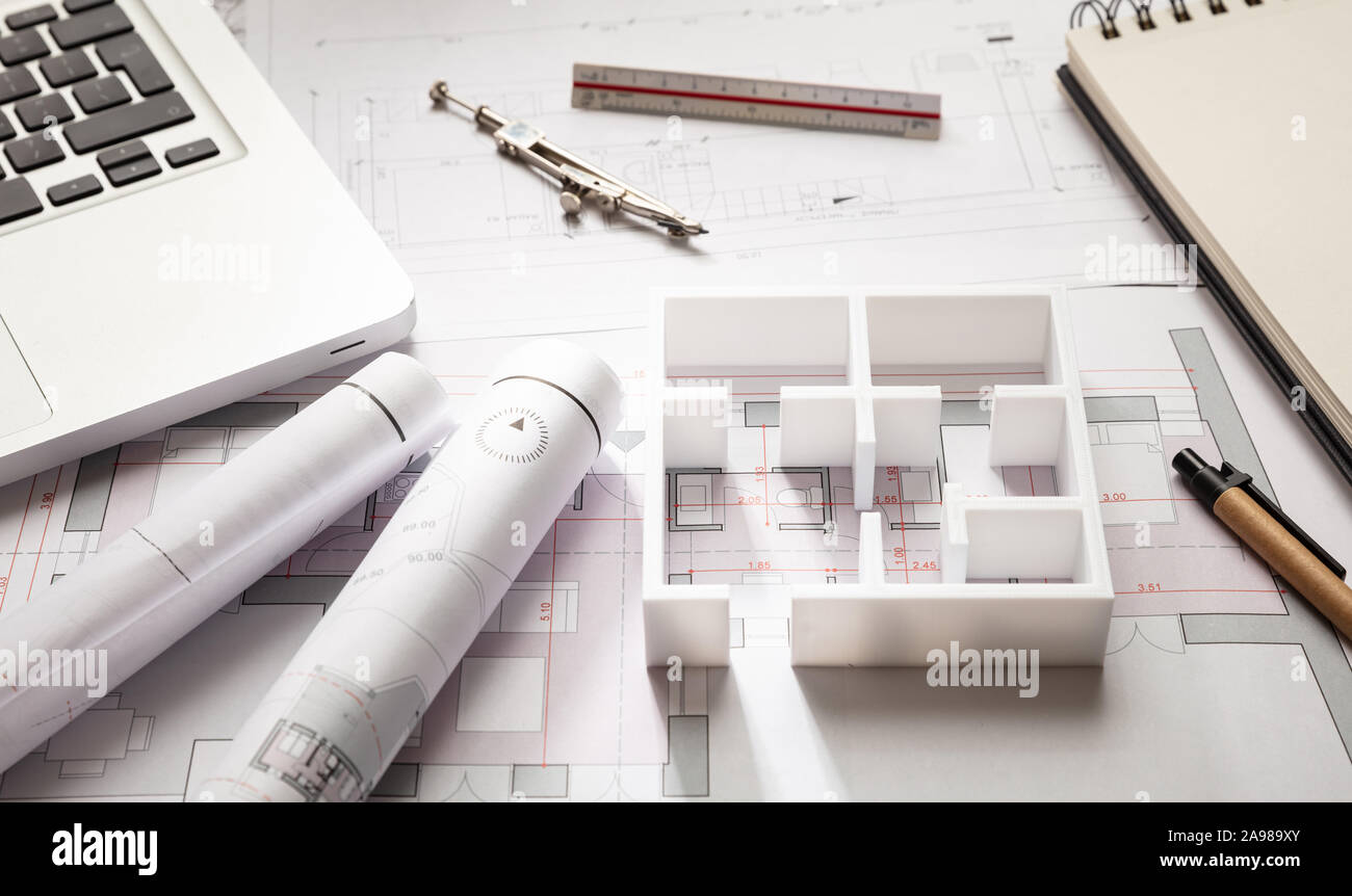 Architect engineer office desk. Blueprint plans and house model,  Residential building project architectural design Stock Photo - Alamy