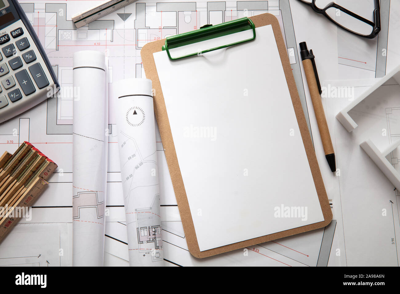 Architect engineer office desk. Blueprint plans, blank clipboard and ...