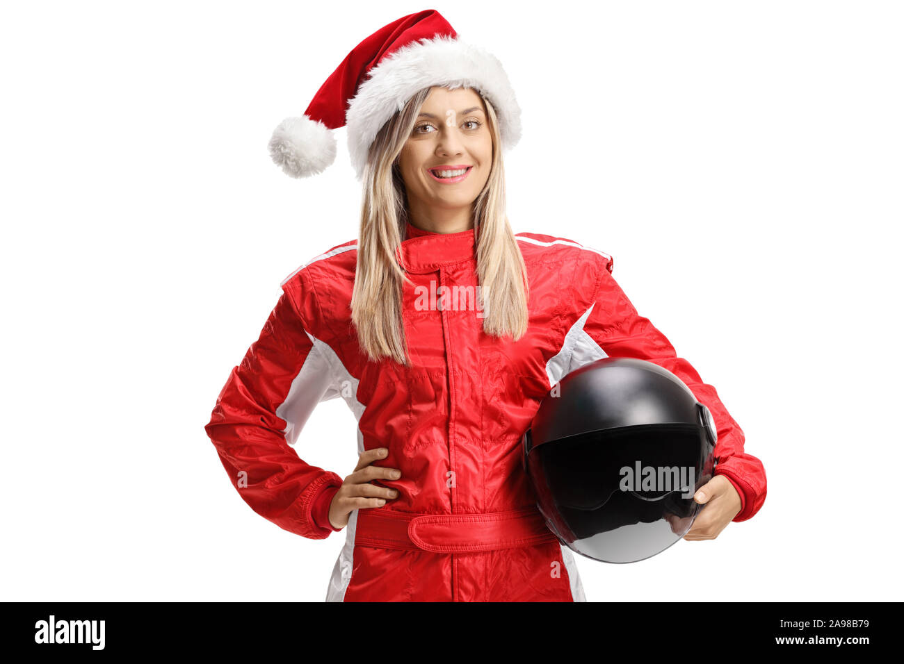 Female racer wearing a Santa Claus hat and holding a helmet isolated on white background Stock Photo