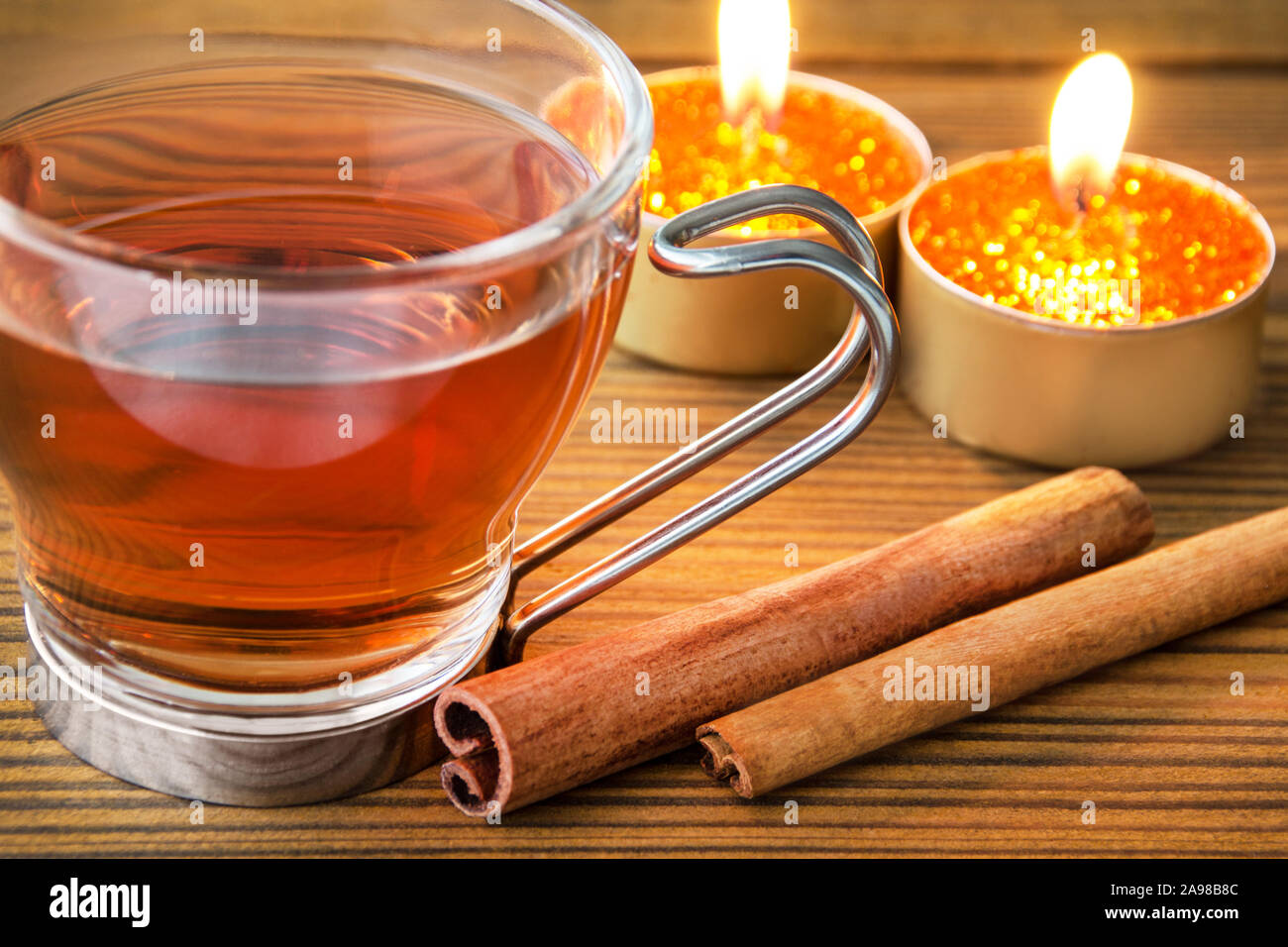 Cinnamon tea and candles Stock Photo