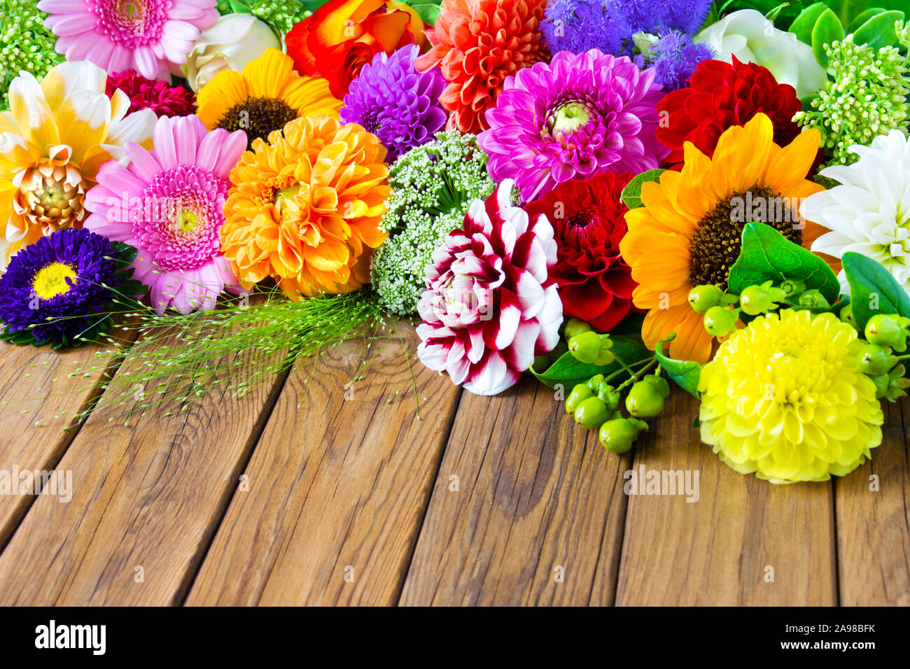 Bouquet of flowers against wooden board Stock Photo