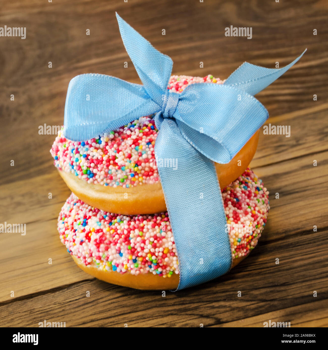 Two Donuts against wooden background Stock Photo