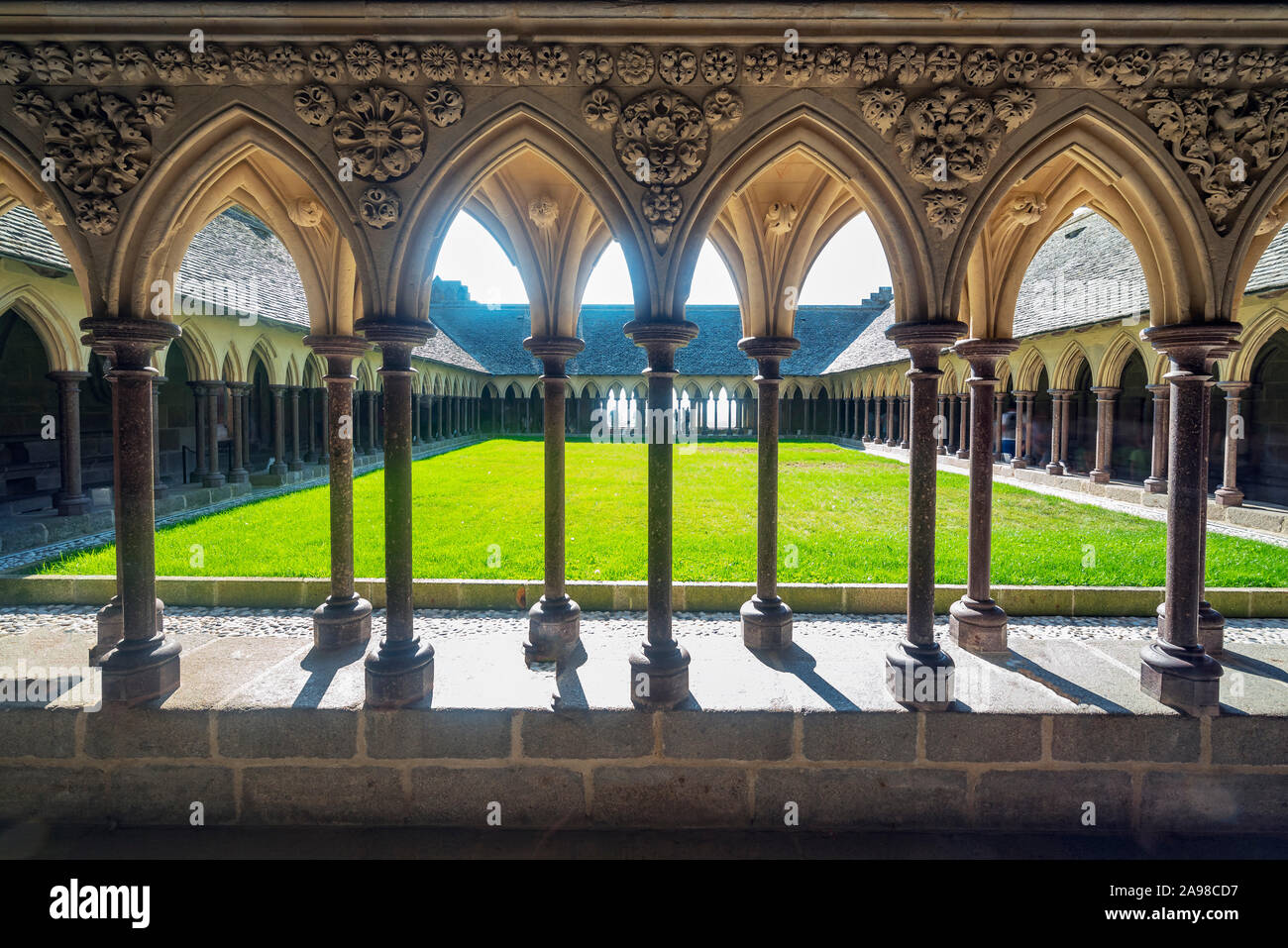 Cloister of the abbey of Mont Saint Michael formed by a succession of columns and arches. Stock Photo