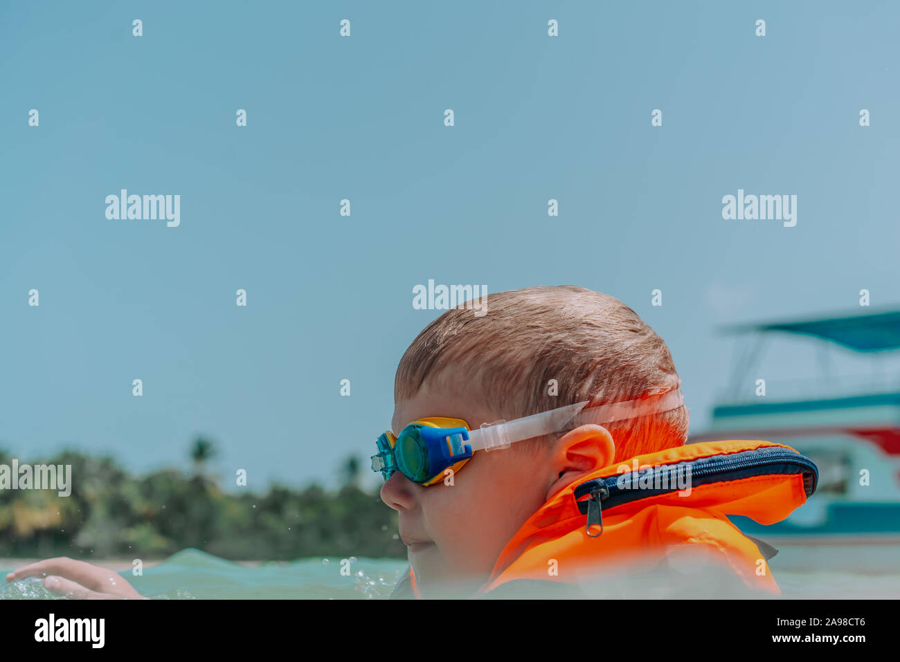 Funny little boy in swimming glasses and vest. Outdoor. Lifestyle. Travel and vacation Stock Photo