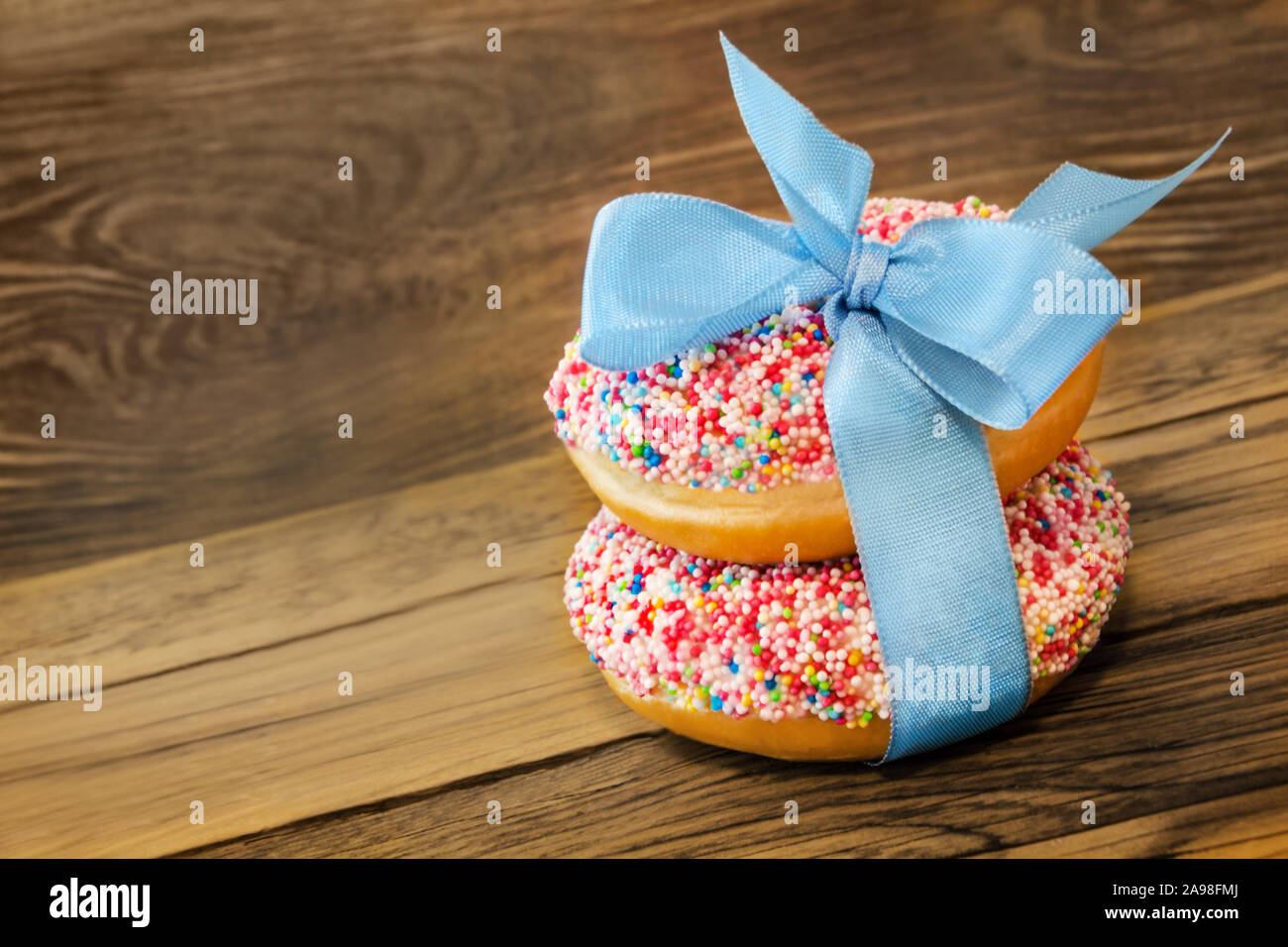 Donuts against wooden background Stock Photo