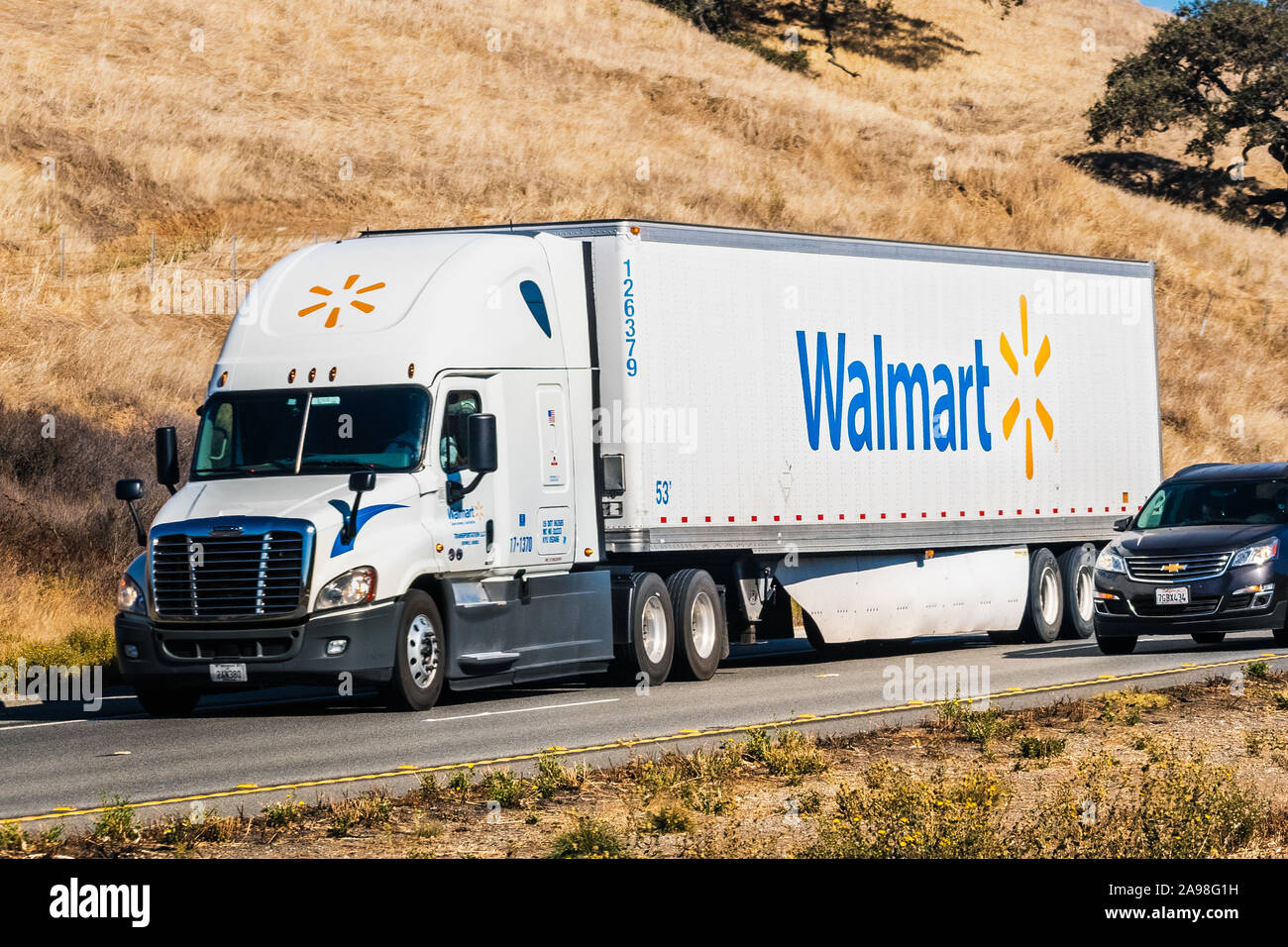 Nov 10, 2019 Hollister / CA / USA - Walmart truck driving on the freeway among hills covered in dry grass Stock Photo