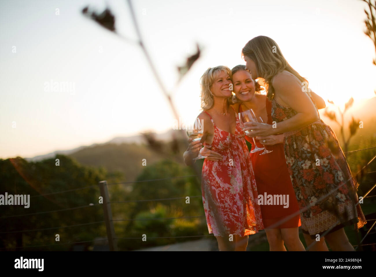 Mid-adult women drinking wind outside. Stock Photo