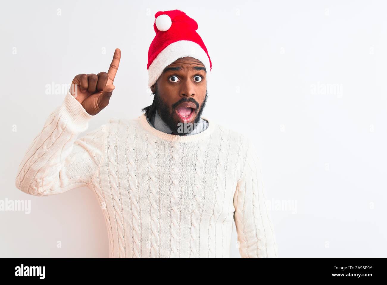 Young african american man wearing Christmas Santa hat over isolated ...