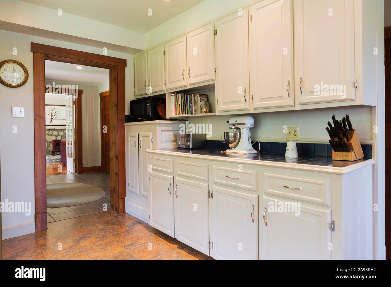 Kitchen With White Pinewood Cabinets Blue Ceramic Countertop And Nuanced Ceramic Tile Floor Inside A 1990s Contemporary Victorian Style Home Stock Photo Alamy