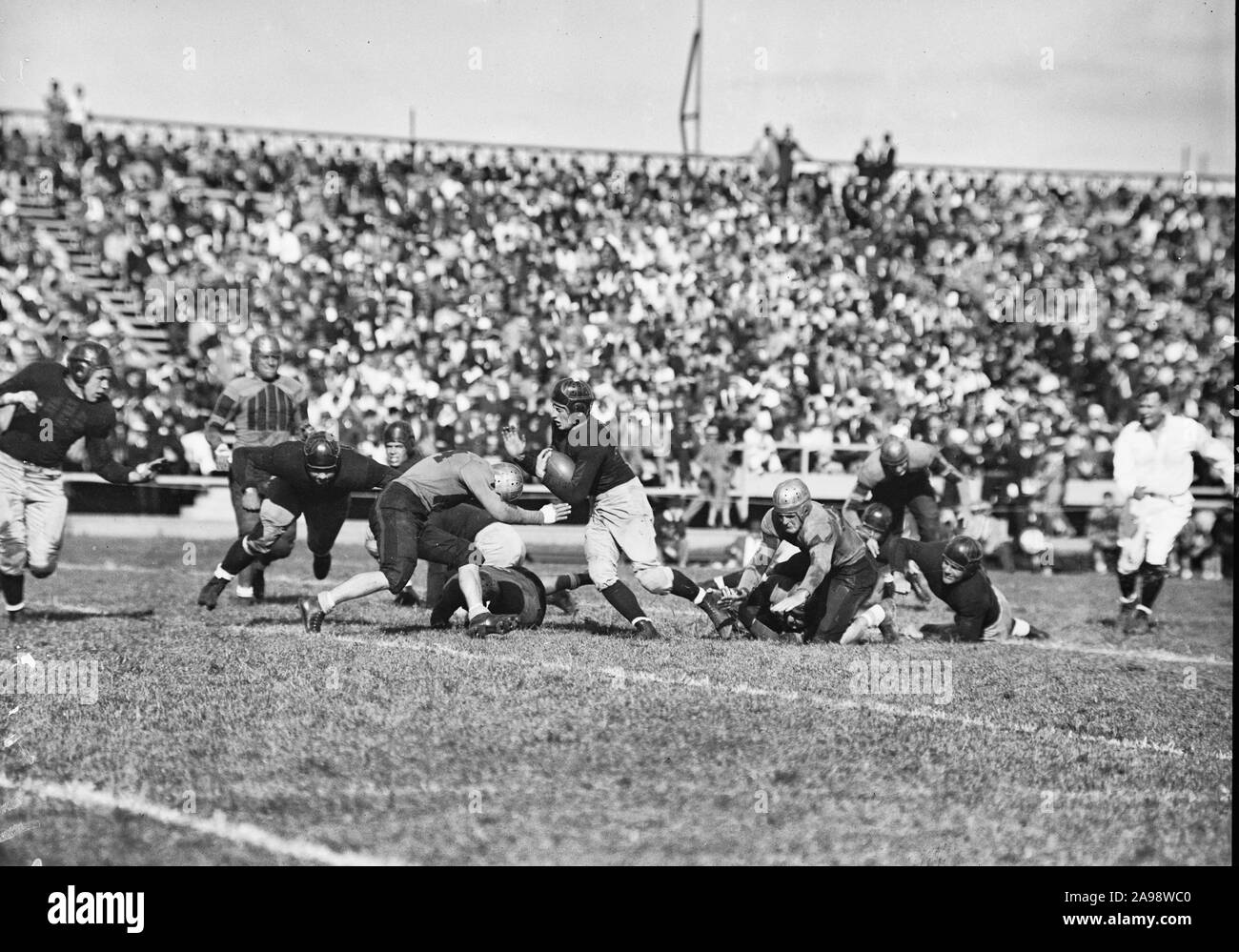 Navy beats William & Mary. Annapolis, MD, September 25, 1936. Navy pried the lid off the 1936 football season here today by trouncing a game but outplayed William & Mary eleven. 18-6. Schmidt, Navy's hard-driving back, is shown going thru William & Mary's line Stock Photo