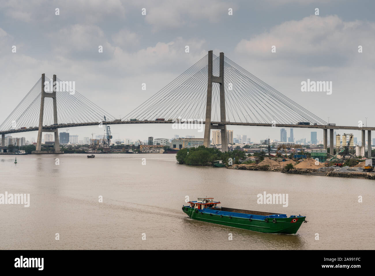 Ho Chi Minh City, Vietnam - March 12, 2019: Long Tau and song Sai Gon rivers meeting point. H-shaped pylons and road of Phu My suspension bridge under Stock Photo