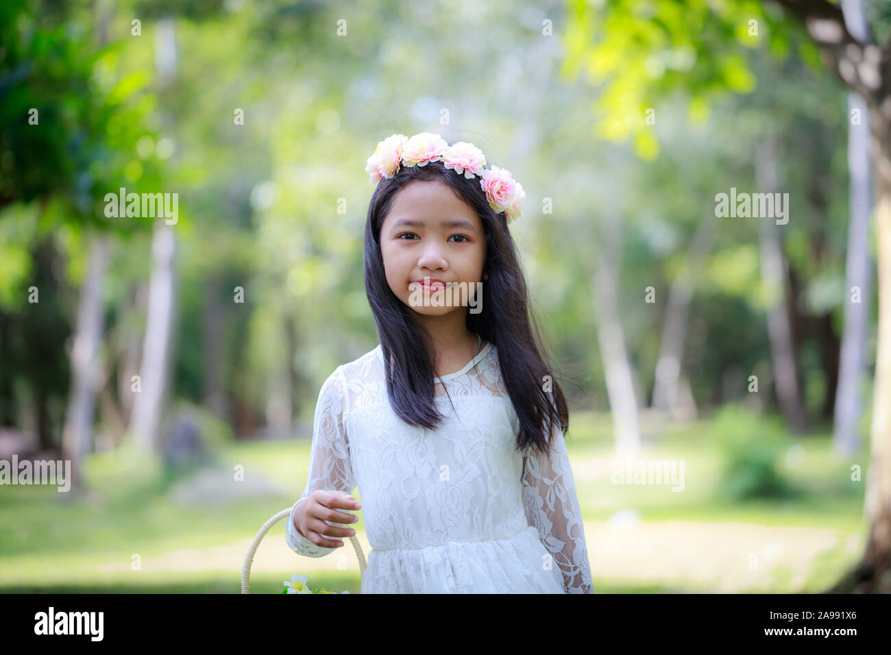 Portrait of little Asian girl smiling in the nature forest with soft ...