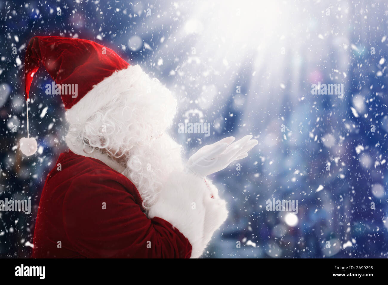 Santa Claus with magic Christmas lights Stock Photo