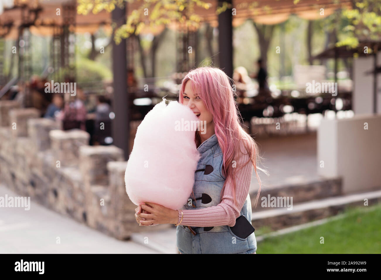 Adorable young woman with long pink hair eats and poses with sugar pink candy cotton. Concept happy times. Carefree girl. Good mood Stock Photo - Alamy Adorable young woman with long pink hair eats and poses with sugar pink candy cotton. Concept happy times. Carefree girl. Good mood Stock Photo - Alamy