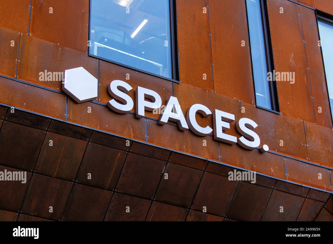 Spaces sign on the build. Co-working business where people can rent space to work at Stock Photo