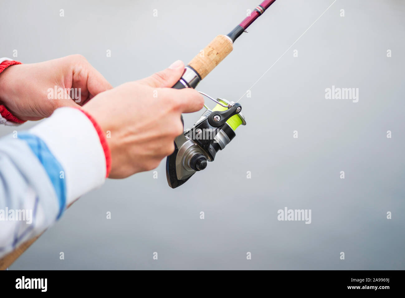 Hands holding a fishing rod hi-res stock photography and images - Alamy