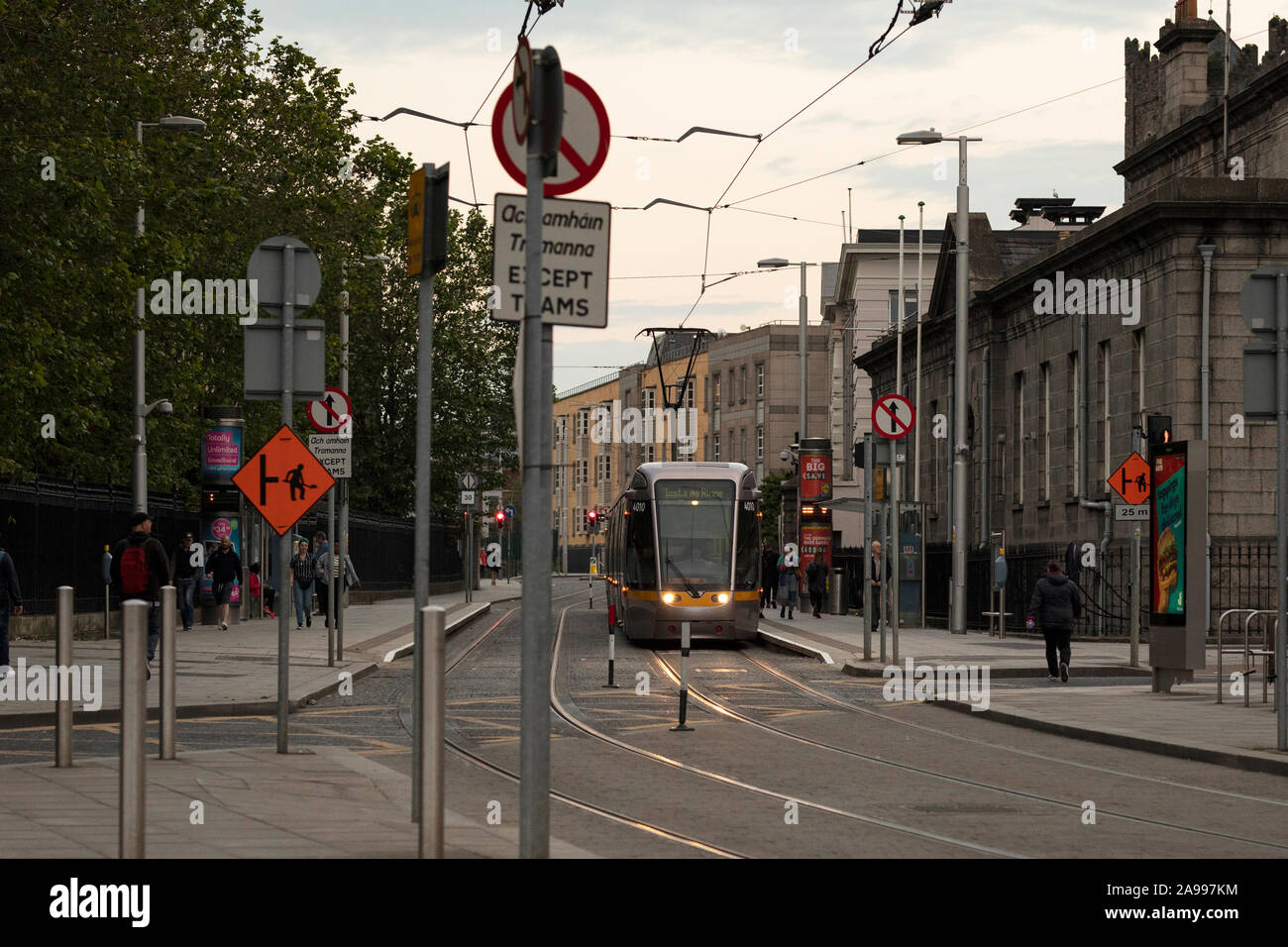 A tram stops in the early evening at Four Courts near Chancery Street and Greek Street on the northside of Dublin, Ireland. Stock Photo