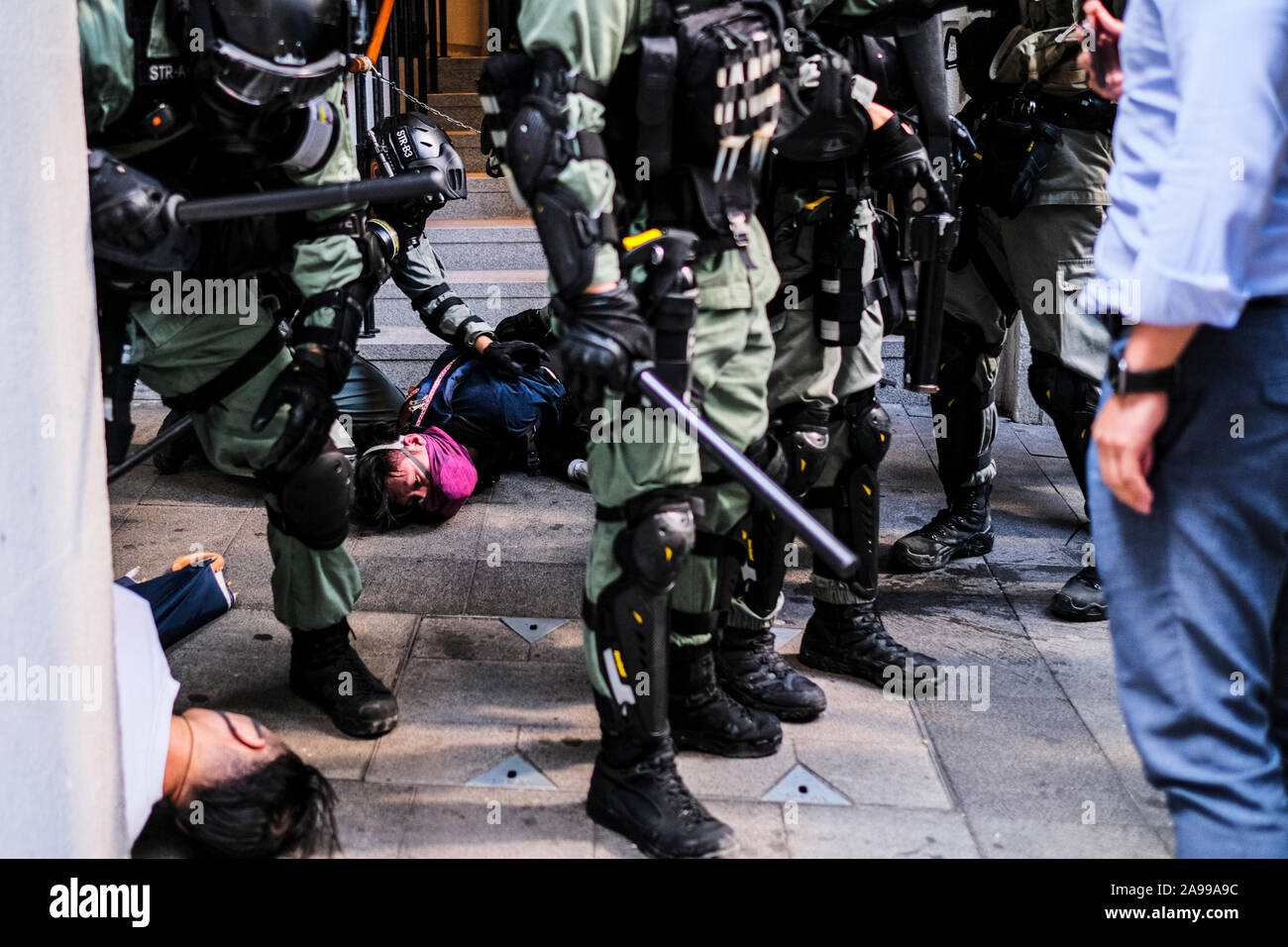 Hong Kong, China. 13th Nov, 2019. Riot police arrest protesters during a protest in the Central district Hong Kong. A 'Blossom Everywhere' action was organized by the protestors to paralyze traffic and vandalize things across Hong Kong for its third consecutive days and have sparked some of the worst violence in five months of unrest. Credit: SOPA Images Limited/Alamy Live News Stock Photo