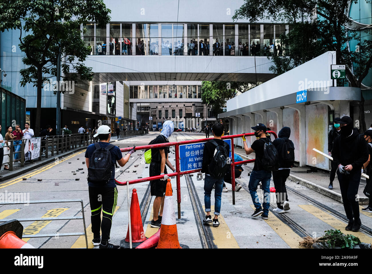 Hong Kong, China. 13th Nov, 2019. Protesters set up barricades and block streets during a protest in the Central district Hong Kong. A 'Blossom Everywhere' action was organized by the protestors to paralyze traffic and vandalize things across Hong Kong for its third consecutive days and have sparked some of the worst violence in five months of unrest. Credit: SOPA Images Limited/Alamy Live News Stock Photo
