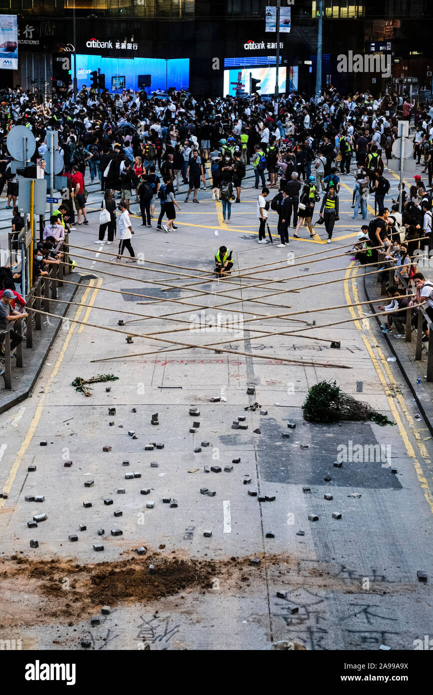 Hong Kong, China. 13th Nov, 2019. Demonstrators set up bricks to block traffic during a protest in the Central district Hong Kong. A 'Blossom Everywhere' action was organized by the protestors to paralyze traffic and vandalize things across Hong Kong for its third consecutive days and have sparked some of the worst violence in five months of unrest. Credit: SOPA Images Limited/Alamy Live News Stock Photo