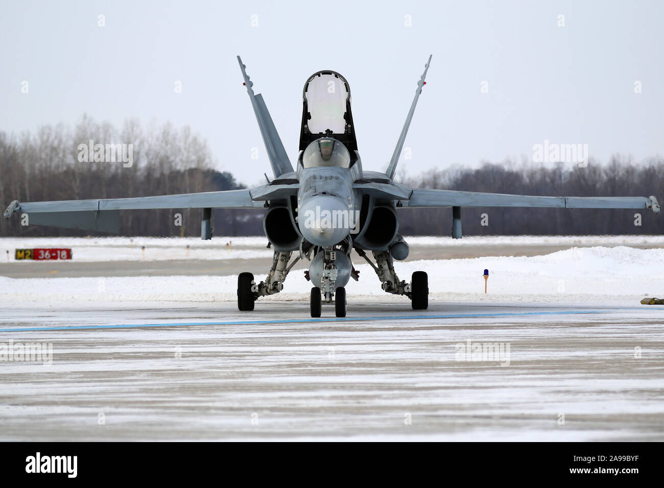 United States Navy F-18 Hornets prepare for a flyover during a Green Bay Packers home game. Stock Photo