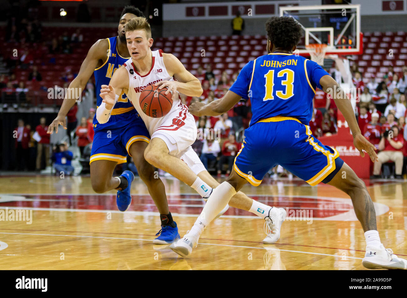 Madison, WI, USA. 13th Nov, 2019. Wisconsin Badgers guard Walt McGrory (3) splits two Cowboy defenders during the NCAA Basketball game between the McNeese State Cowboys and the Wisconsin Badgers at the Kohl Center in Madison, WI. John Fisher/CSM/Alamy Live News Stock Photo
