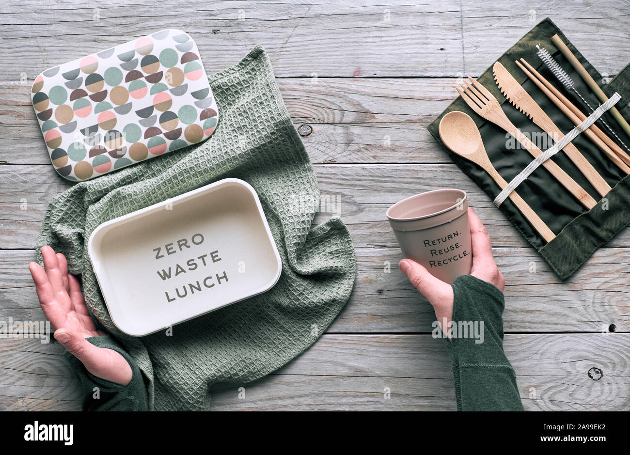 Creative flat lay, zero waste packed lunch concept, reusable wooden cutlery, lunch box in cotton cloth and reusable coffee cup. Sustainable lifestyle Stock Photo