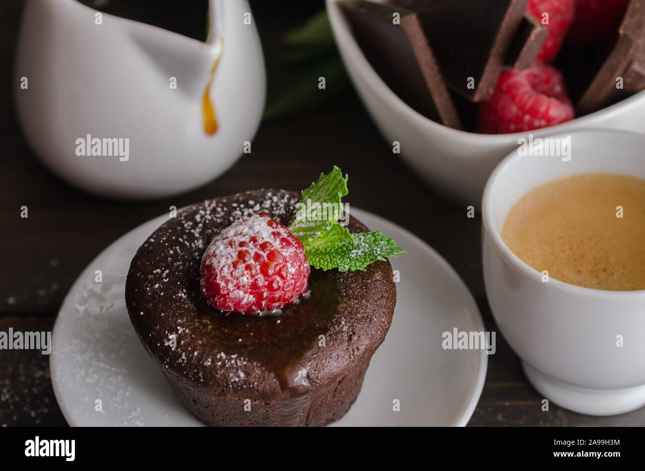 Chocolate fondant with raspberryand coffee cup. Molten chocolate cake