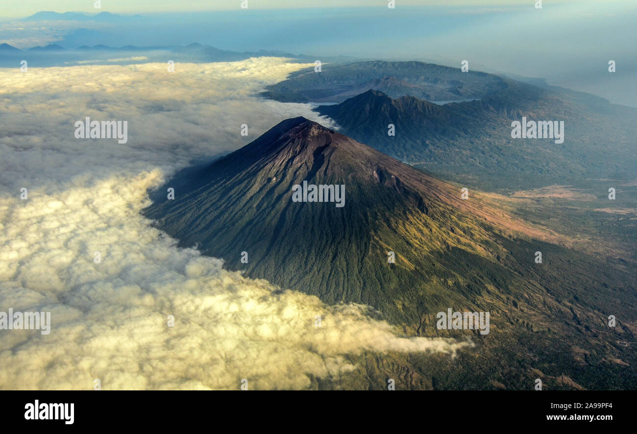 Mount Agung covered with cloud with mount Batur in the background. Stock Photo