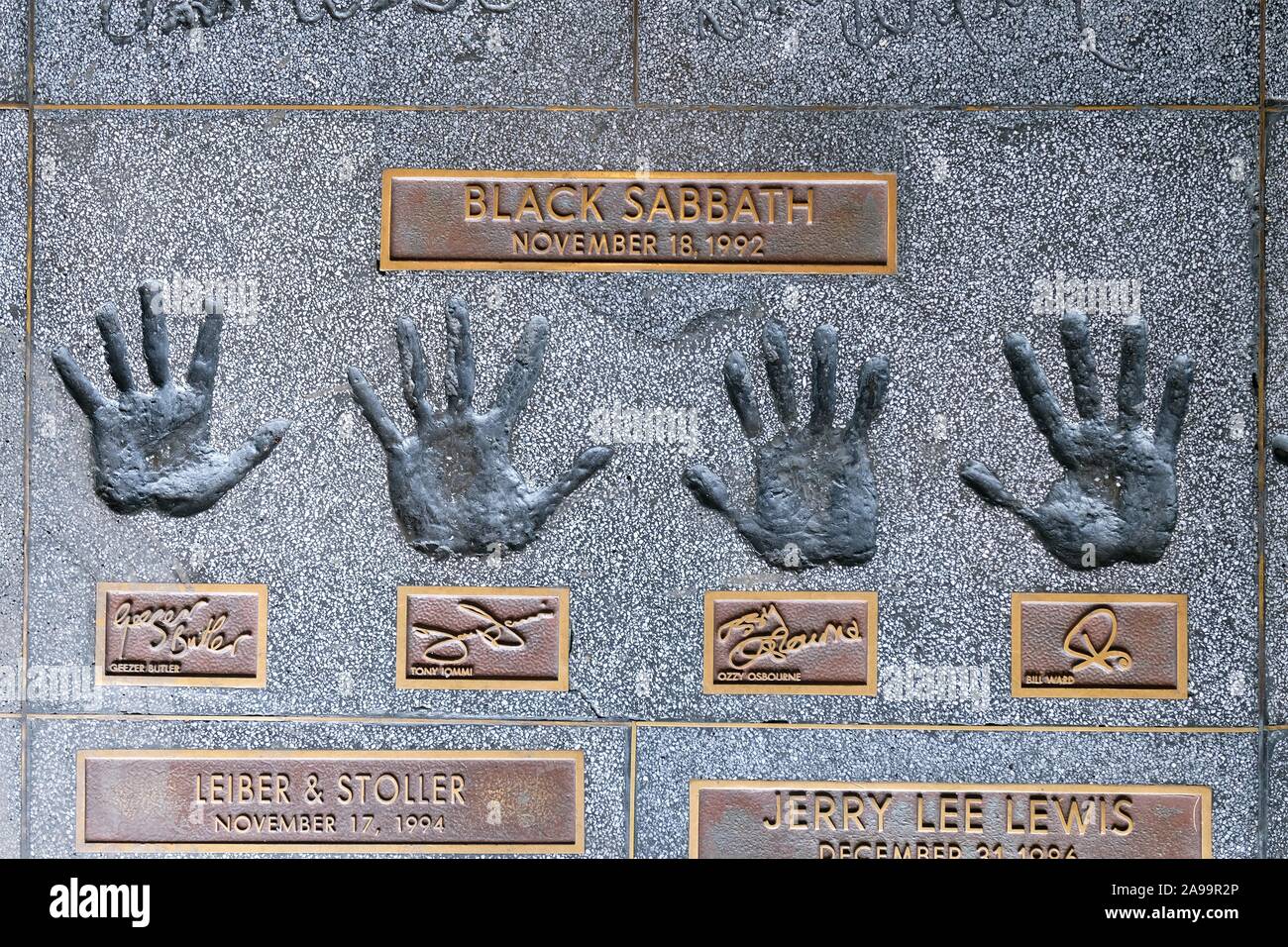 Hands of the band Black Sabbath with Geezer ButlerTony Iommi, Ozzy Osbourne, Bill Ward, Rock Walk on Sunset Boulevard, Hollywood, Los Angeles Stock Photo