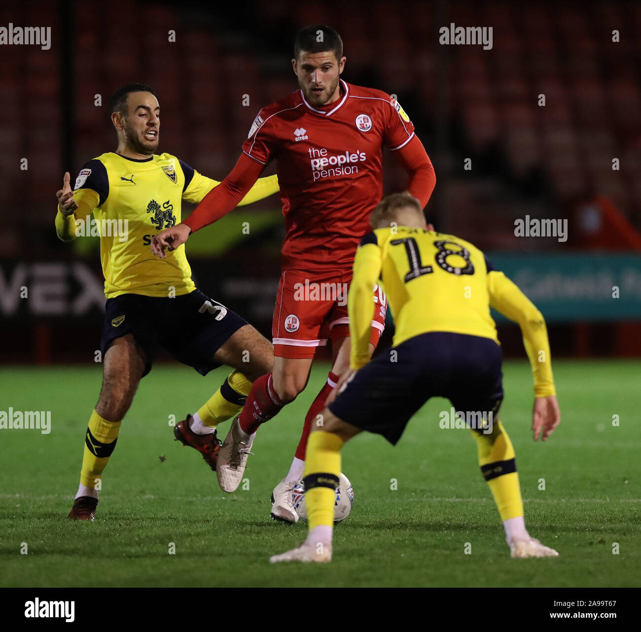 Crawley Town's Jamie Sendles-White  vies for the ball against Oxford's Mark Sykes during the Leasing.com Trophy match between Crawley Town and Oxford United at the Peoples Pension Stadium in Crawley. 12 November 2019 Stock Photo