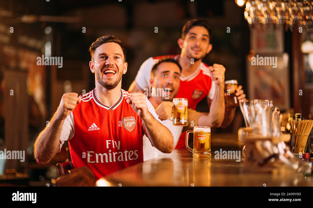 Party excited arsenal fans watching soccer with Ganzberg Beer in the