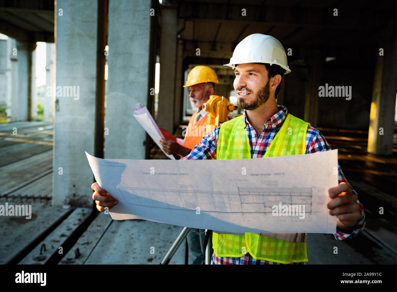 Picture of construction site engineer looking at blueprint Stock Photo ...