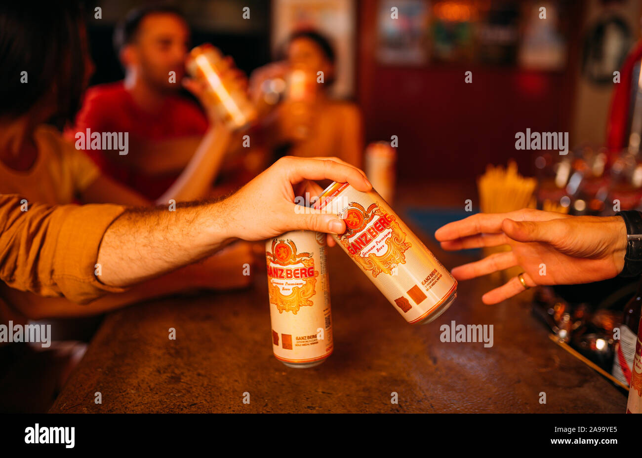 party friends drinking ganzberg beer at bar or pub Stock Photo