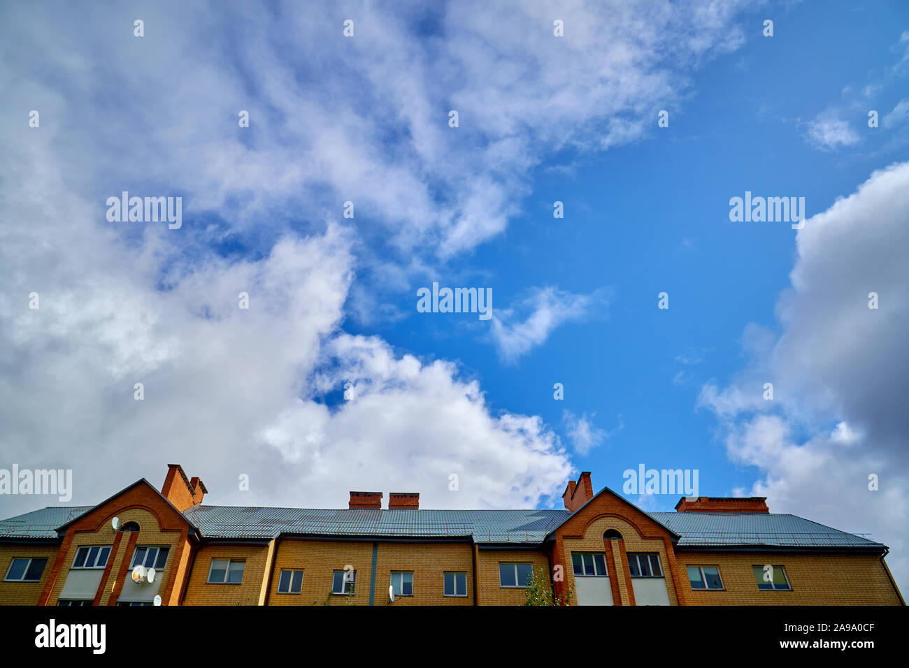House roof and blue sky with clouds Stock Photo - Alamy
