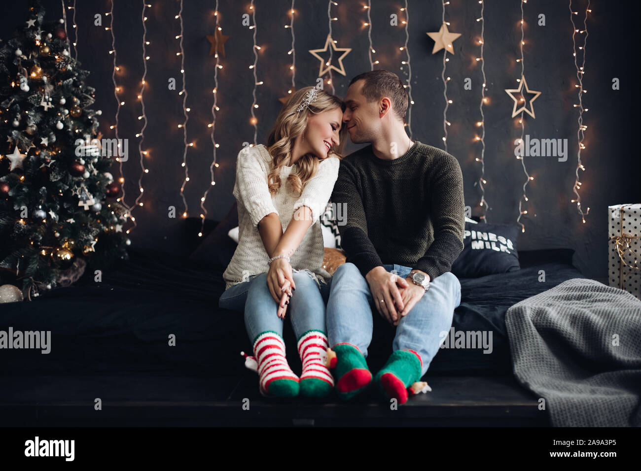 Cheerful couple in bright socks on bed Stock Photo - Alamy