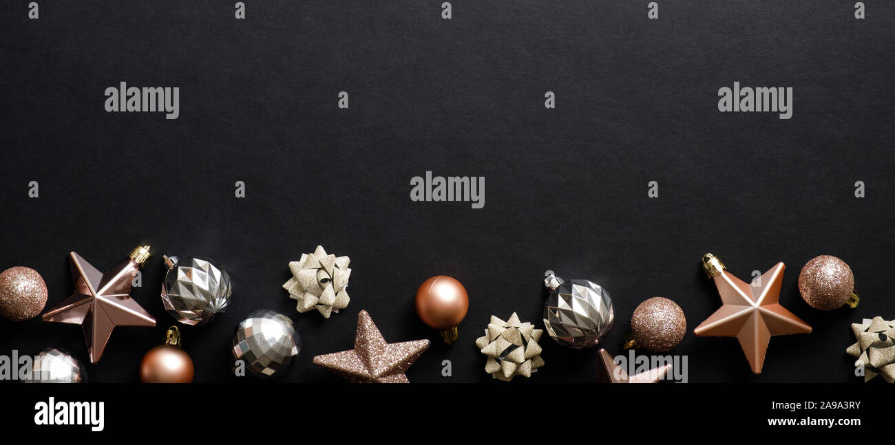 Christmas banner. Xmas black background with stylish balls and stars. Flat lay, top view. Stock Photo