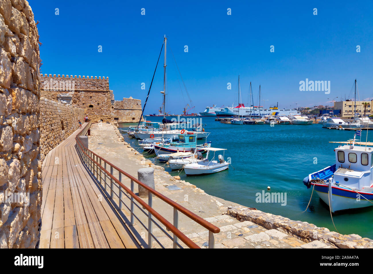 HERAKLION, CRETE ISLAND, GREECE – JUN 22, 2019: View of Venetian Koules Fortress – Castello a Mare and boats in Heraklion harbor. Image Stock Photo