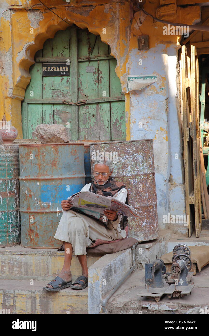 BUNDI, RAJASTHAN, INDIA - DECEMBER 08, 2017: A street vendor reading a newspaper inside the old city Stock Photo