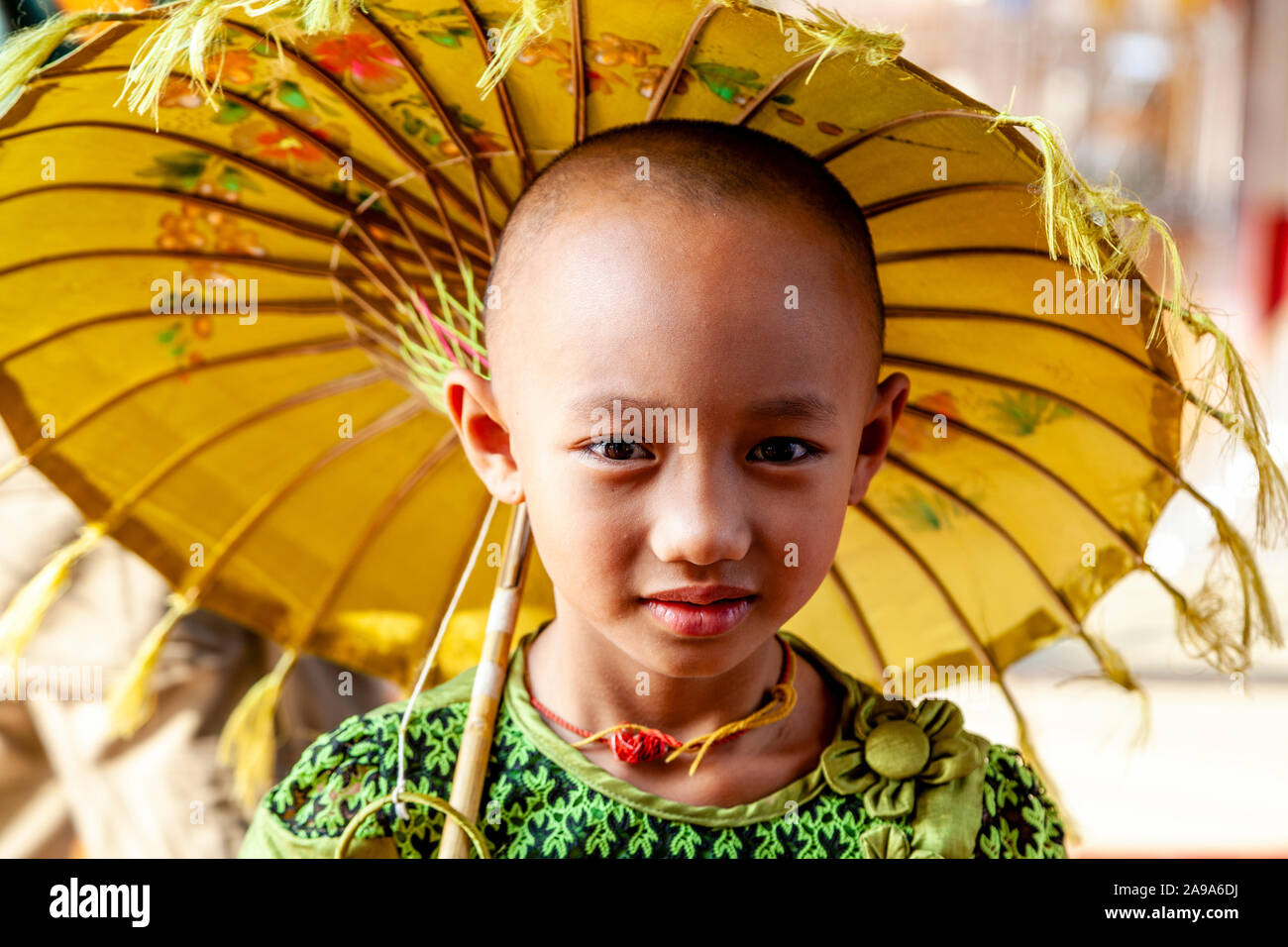 A Burmese Girl With Parasol, Su Taung Pyae Pagoda, Mandalay Hill, Mandalay, Myanmar. Stock Photo