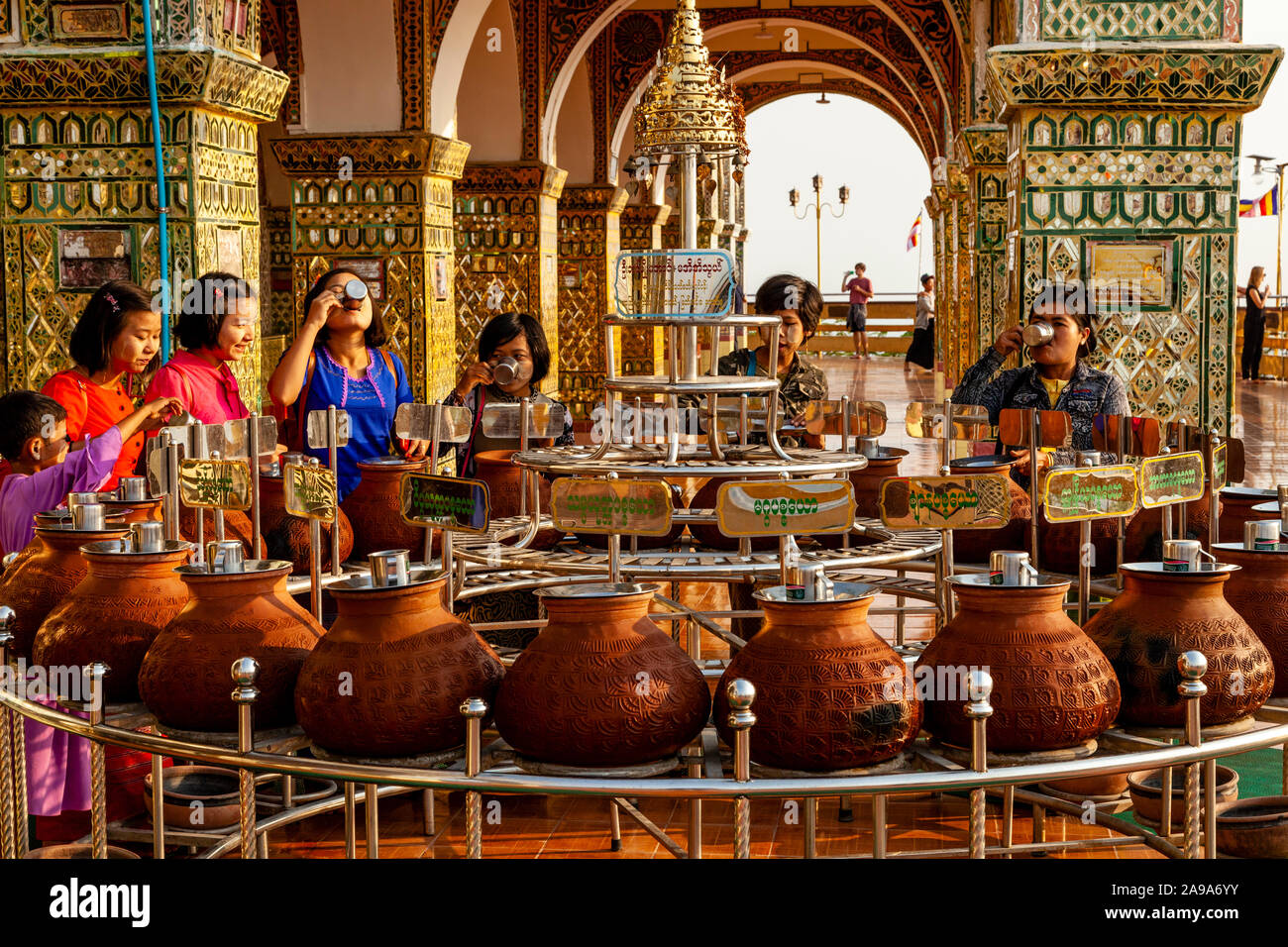 Buddhists Drinking Water From Clay Pots, Su Taung Pyae Pagoda, Mandalay Hill, Mandalay, Myanmar. Stock Photo
