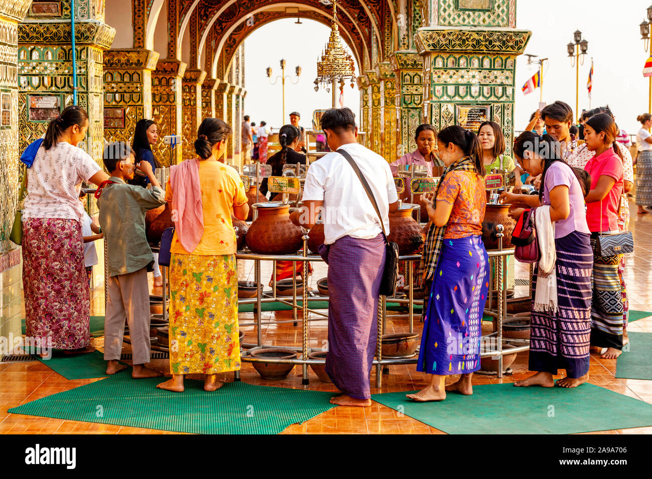 Buddhists Drinking Water From Clay Pots, Su Taung Pyae Pagoda, Mandalay Hill, Mandalay, Myanmar. Stock Photo
