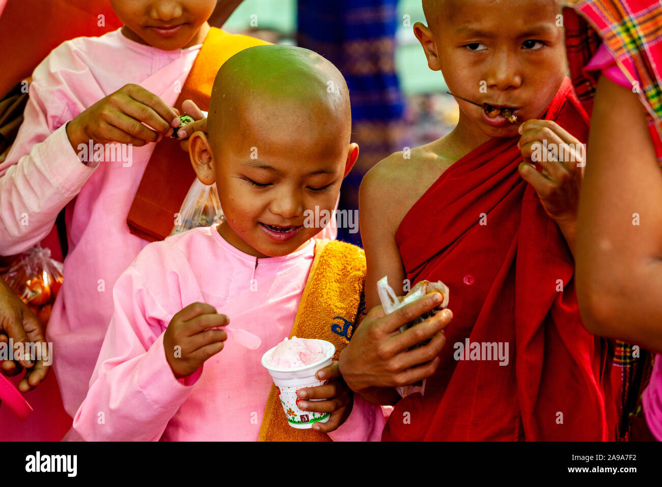 A Novice Nun Eating Ice Cream At The Soon Oo Pon Nya Shin Paya, Sagaing, Mandalay, Myanmar. Stock Photo