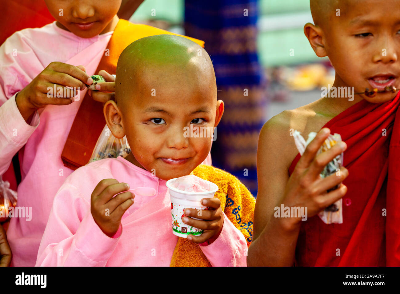 A Novice Nun Eating Ice Cream At The Soon Oo Pon Nya Shin Paya, Sagaing, Mandalay, Myanmar. Stock Photo