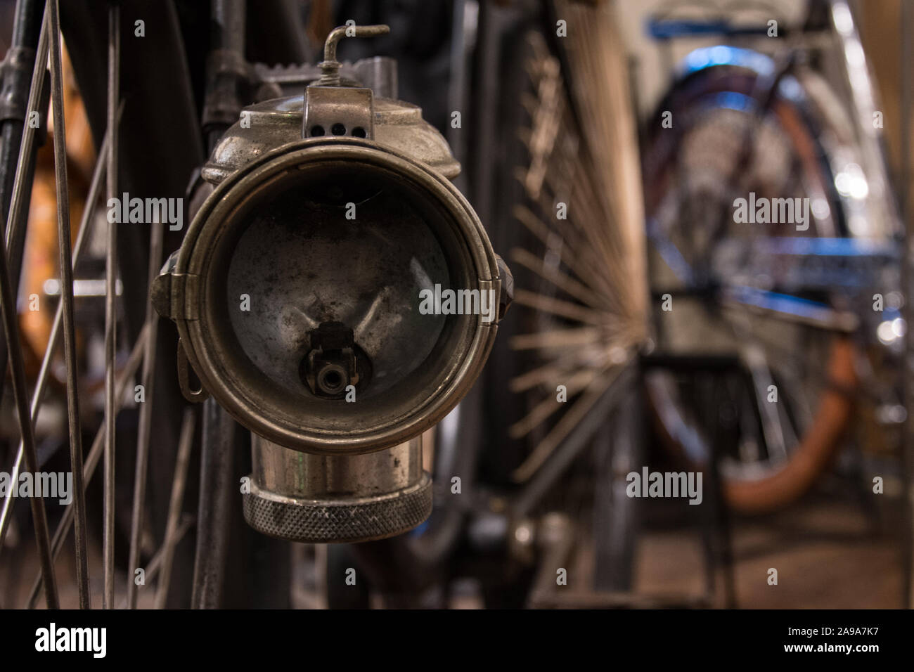 Vintage bike lamp with antique bikes in the background Stock Photo