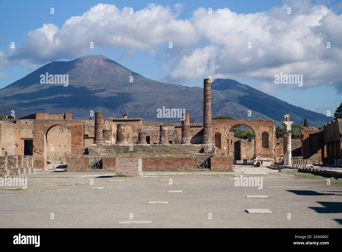 Pompei. Italy. Archaeological site of Pompeii. View of the Civil Forum (Foro Civile), towards the Capitolium, Mount Vesuvius in the background.  Regio Stock Photo